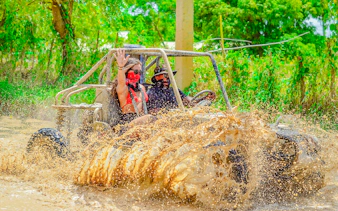 Buggy adventure through muddy terrain in Punta Cana, part of Higüey City Tour experience.
