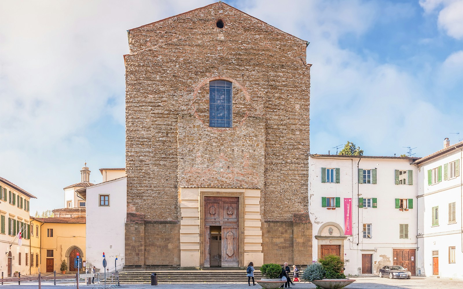 Church of Santa Maria del Carmine facade in Florence, Italy, with surrounding buildings.