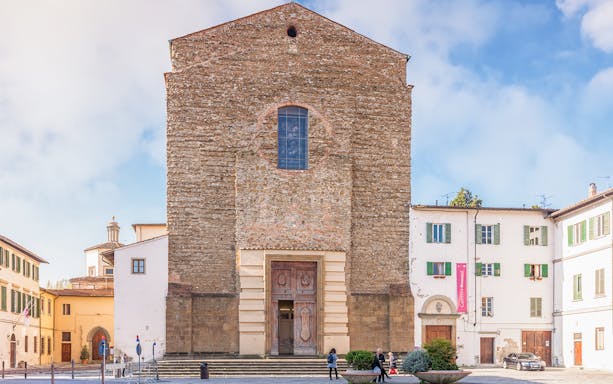 Church of Santa Maria del Carmine facade in Florence, Italy, with surrounding buildings.
