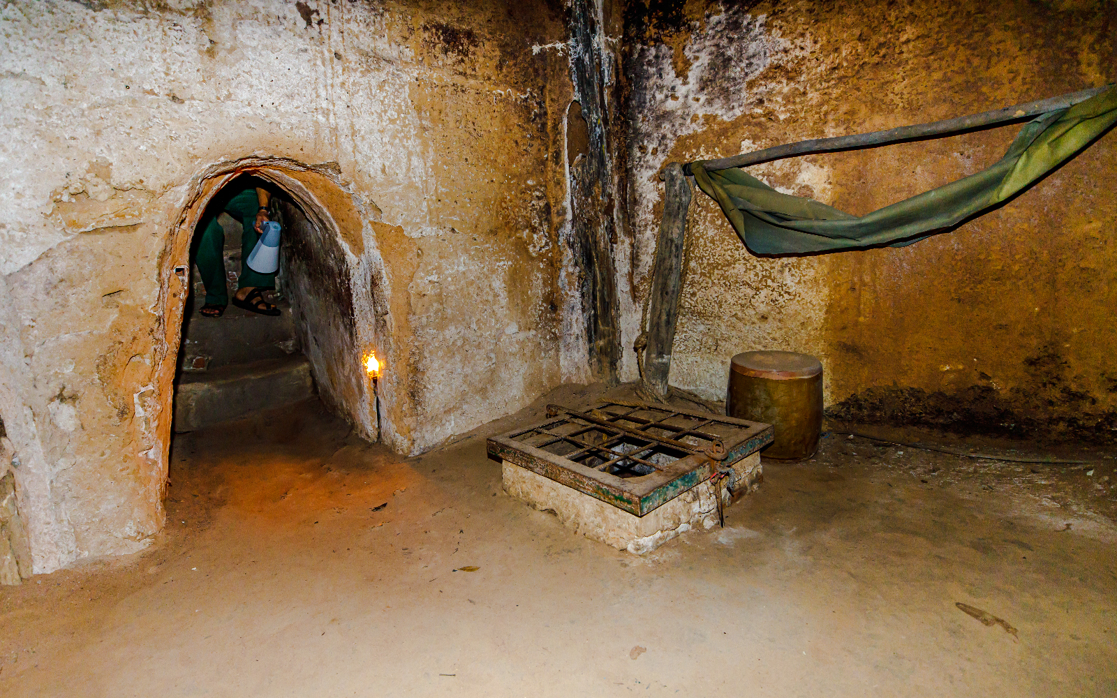Sleeping quarters inside Cu Chi tunnels, Vietnam, with hammock and entrance passage.