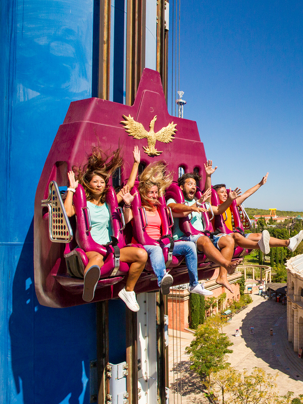 Visitors enjoying a thrilling drop tower ride at a theme park in Spain.