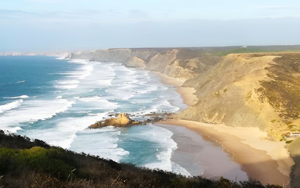 Vicentina Coast cliffs and ocean waves in Southwest Alentejo Natural Park.