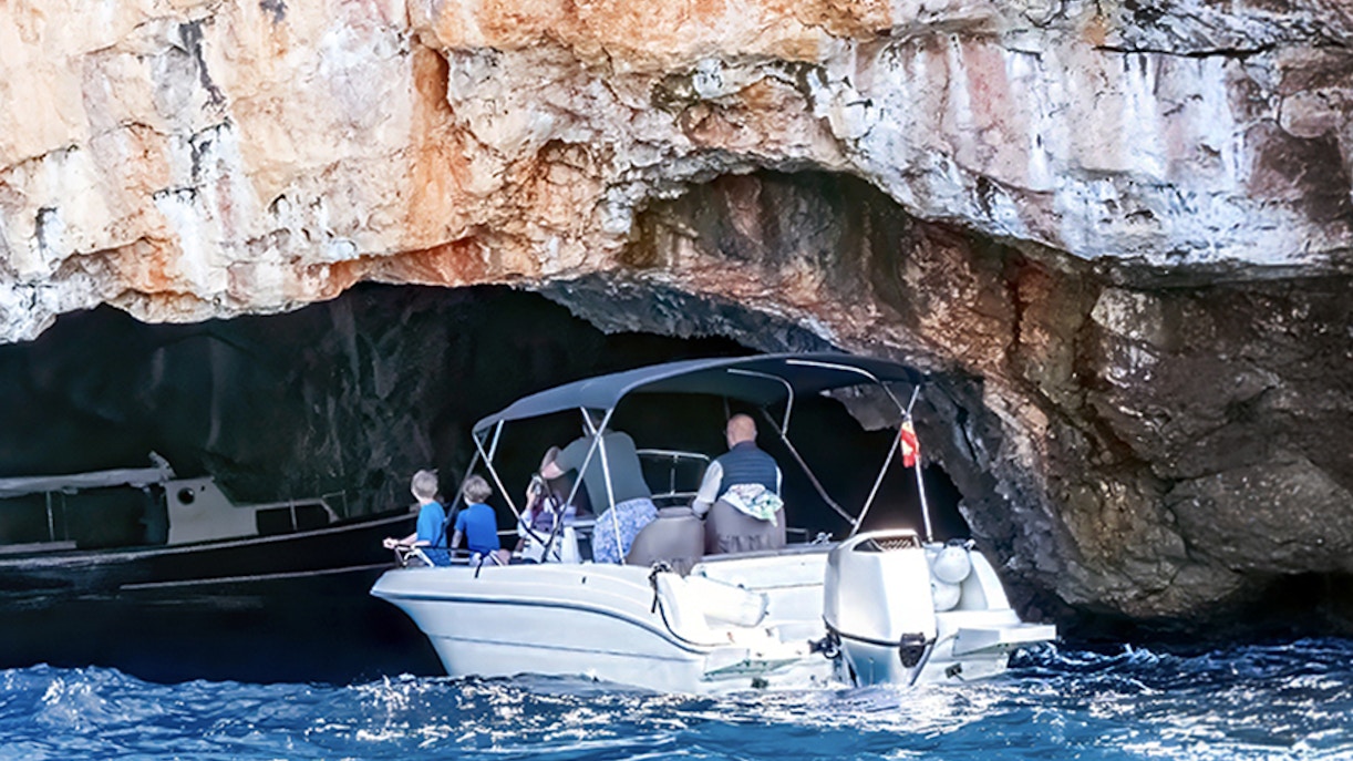 Boat entering Blue Cave on Lustica Peninsula, Montenegro.