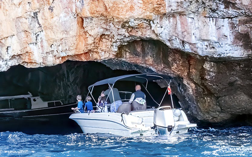 Boat entering Blue Cave on Lustica Peninsula, Montenegro.