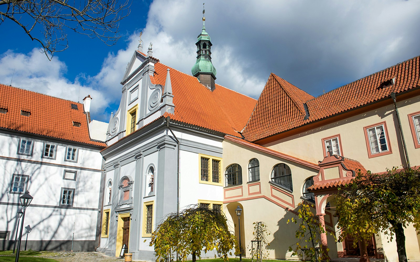 Minorite Monastery courtyard with historic architecture in Český Krumlov, Czech Republic.