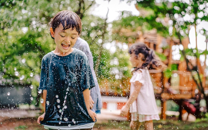 Children playing in water at Moominvalley Park.