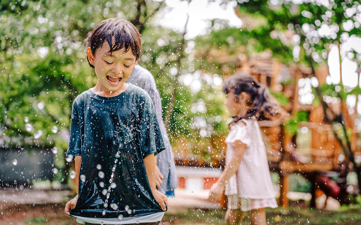 Children playing in water at Moominvalley Park.