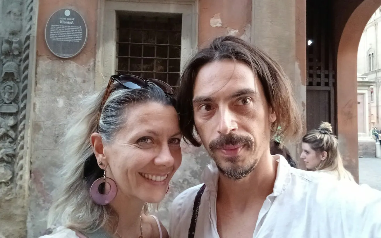 Couple exploring Bologna during a self-guided murder mystery city game.