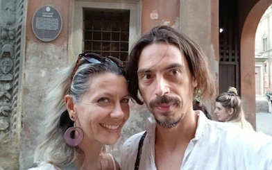 Couple exploring Bologna during a self-guided murder mystery city game.