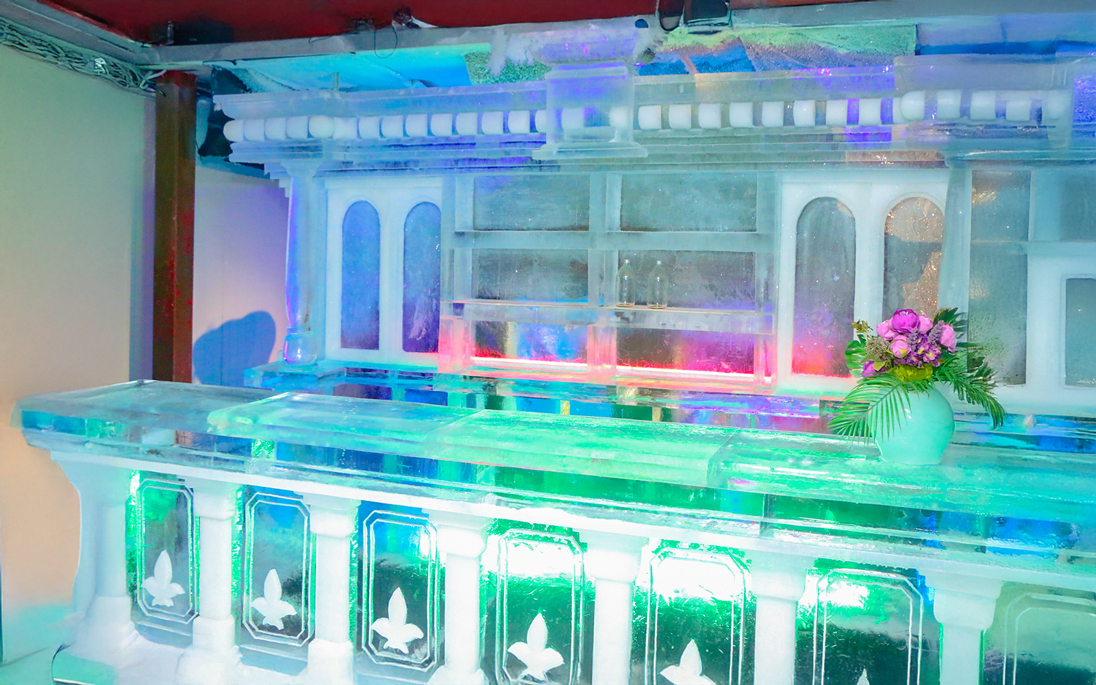 Ice bar counter with colorful lights at Rainbow Frosty Playground, Singapore Snow City.