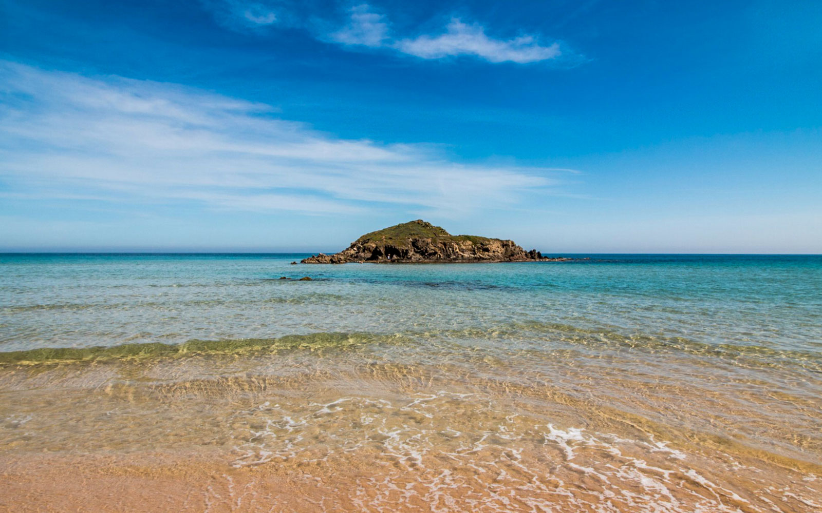 Chia beach with clear water and small island, part of Cagliari 4x4 tour.