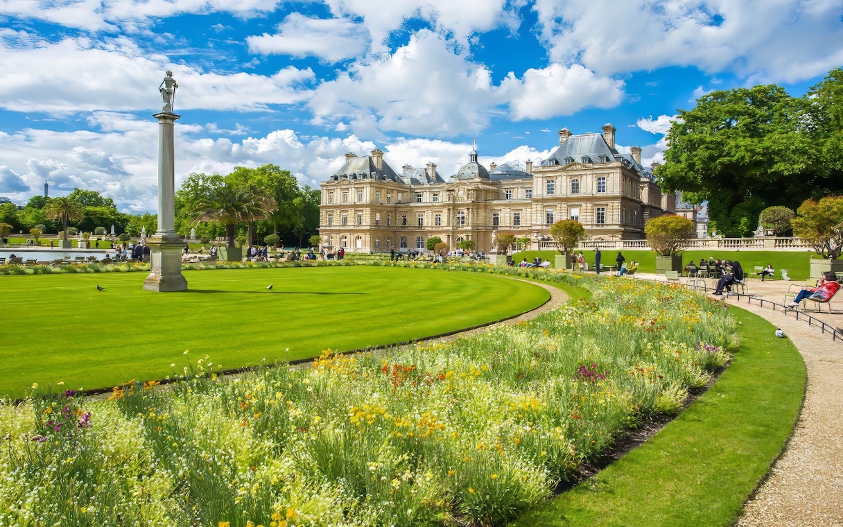 Luxembourg Gardens Paris with palace and vibrant flowerbeds.