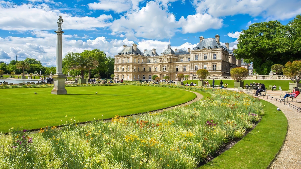 Luxembourg Gardens Paris with palace and vibrant flowerbeds.