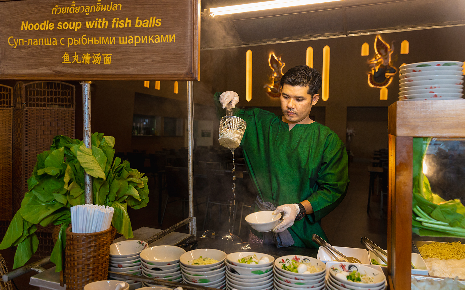 Vendor preparing noodle soup at Siam Niramit buffet.