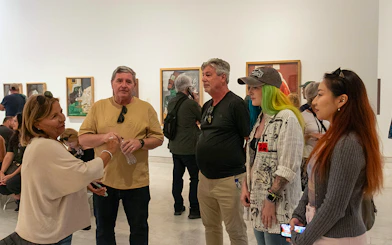 Visitors on a guided tour at the Picasso Museum, viewing artwork.