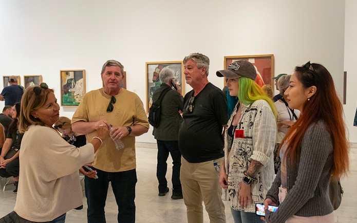 Visitors on a guided tour at the Picasso Museum, viewing artwork.