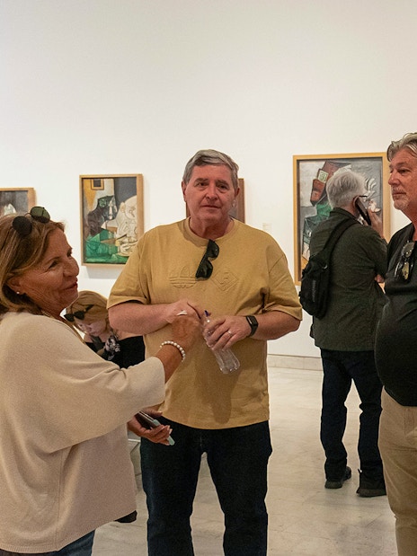 Visitors on a guided tour at the Picasso Museum, viewing artwork.