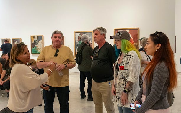 Visitors on a guided tour at the Picasso Museum, viewing artwork.