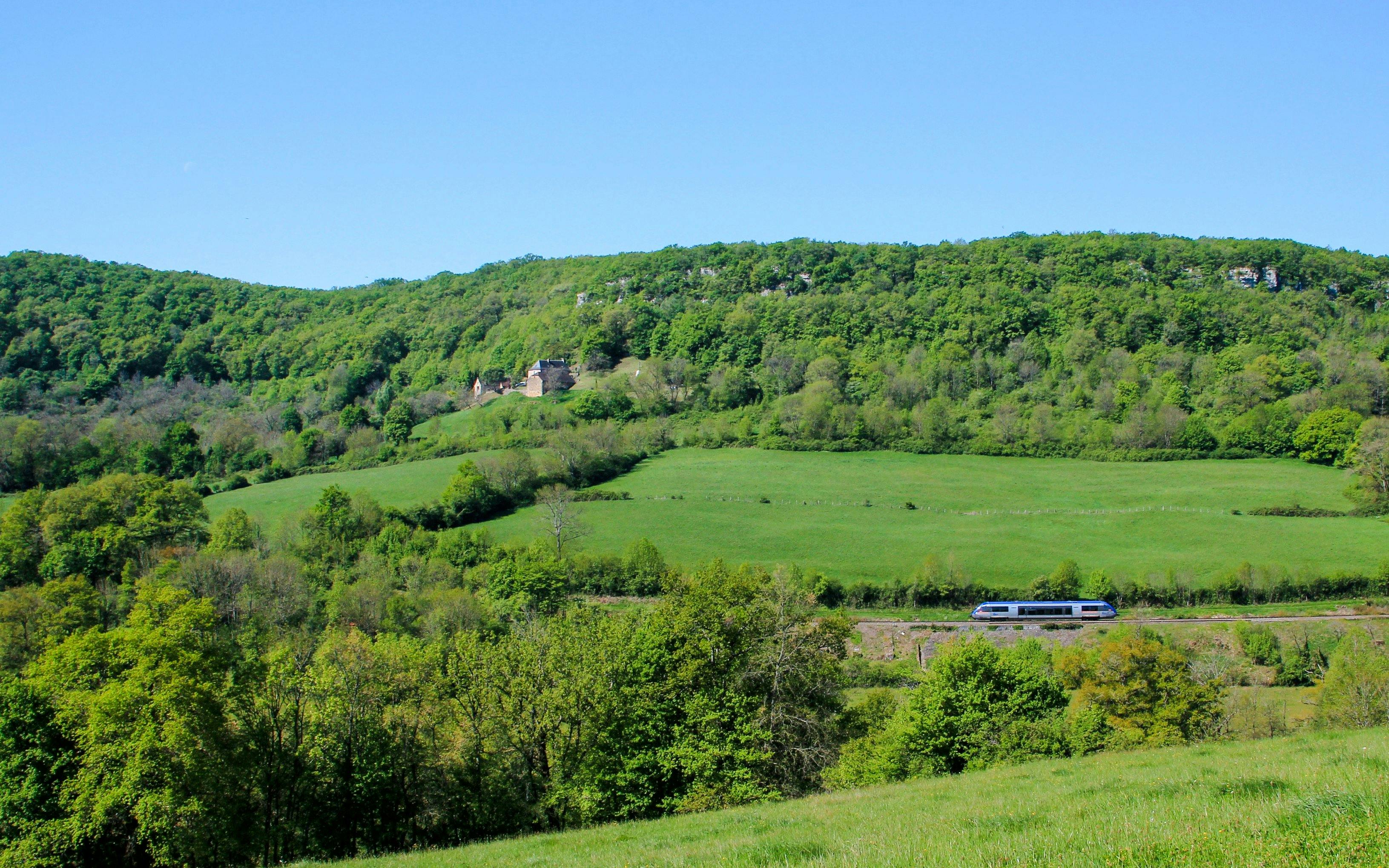 TER train traveling through lush countryside in France.