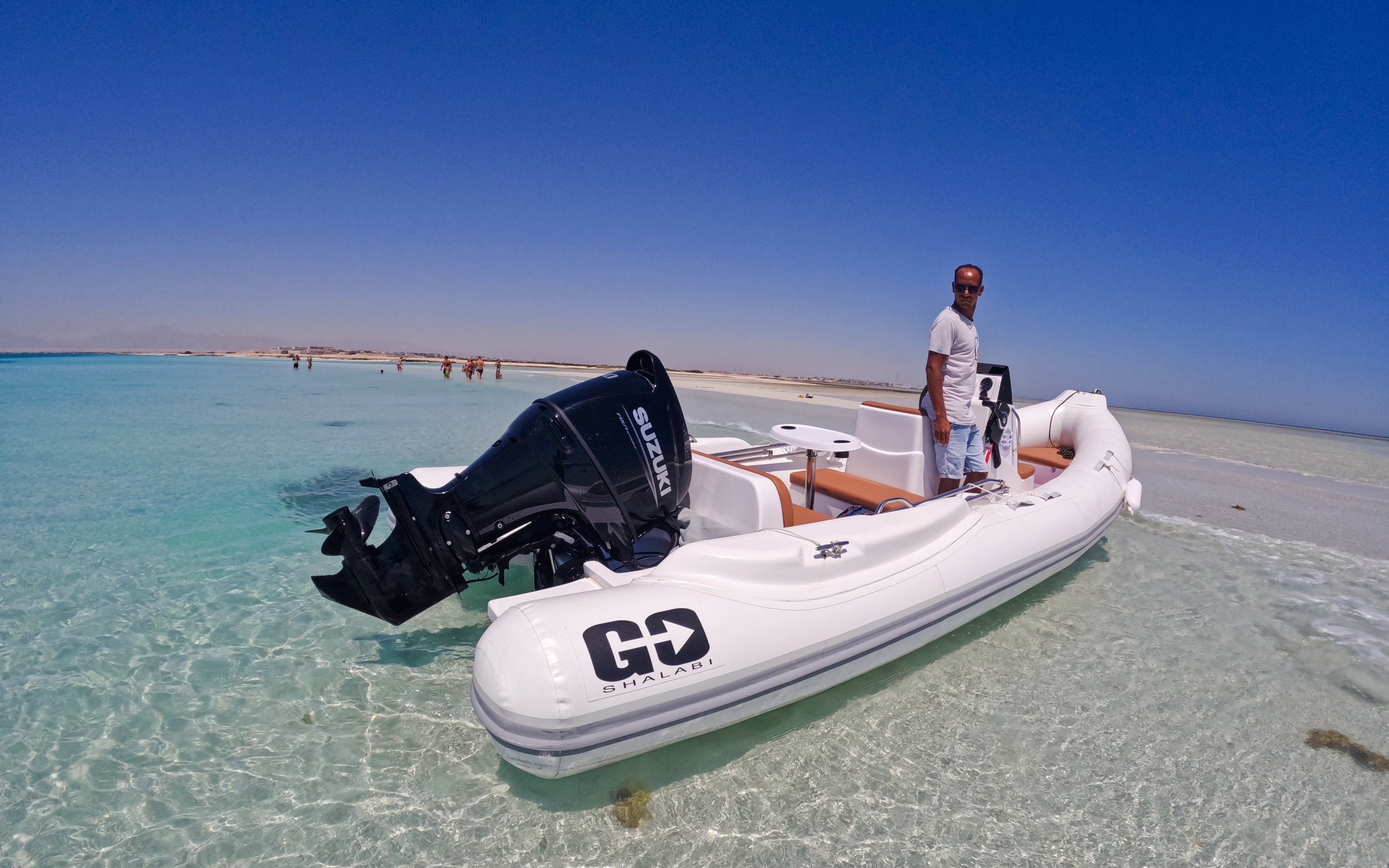 Boat anchored on clear waters during Giftun 3 Islands Tour, Egypt.