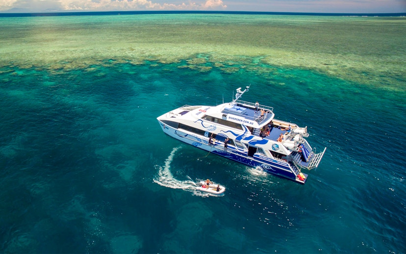 Catamaran on Outer Great Barrier Reef tour from Cairns with passengers enjoying the view.