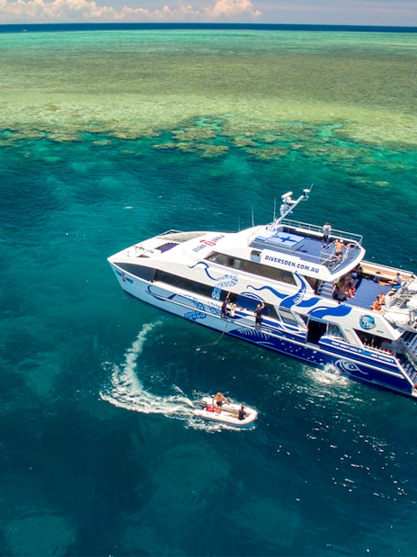 Catamaran on Outer Great Barrier Reef tour from Cairns with passengers enjoying the view.