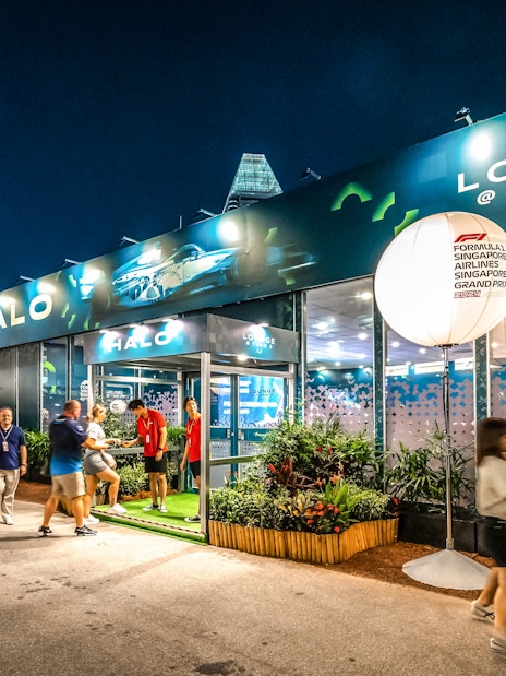 Marina Bay Street Circuit lounge entrance with visitors during Singapore Grand Prix.