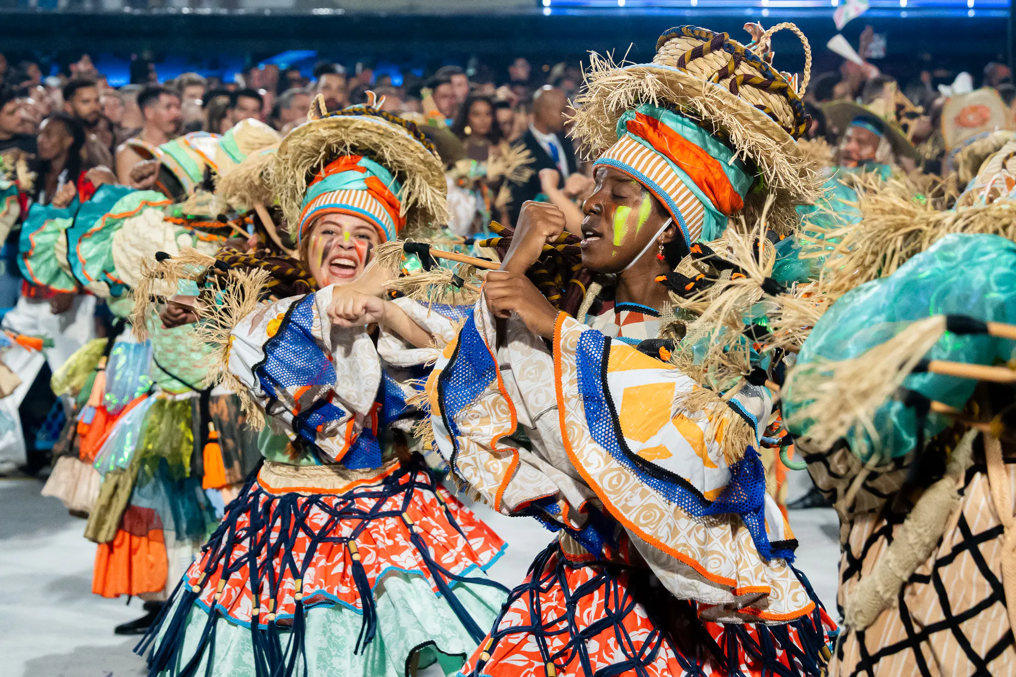 Performers in colorful costumes dancing at the Rio Carnival Sambadrome Parade, Rio de Janeiro.