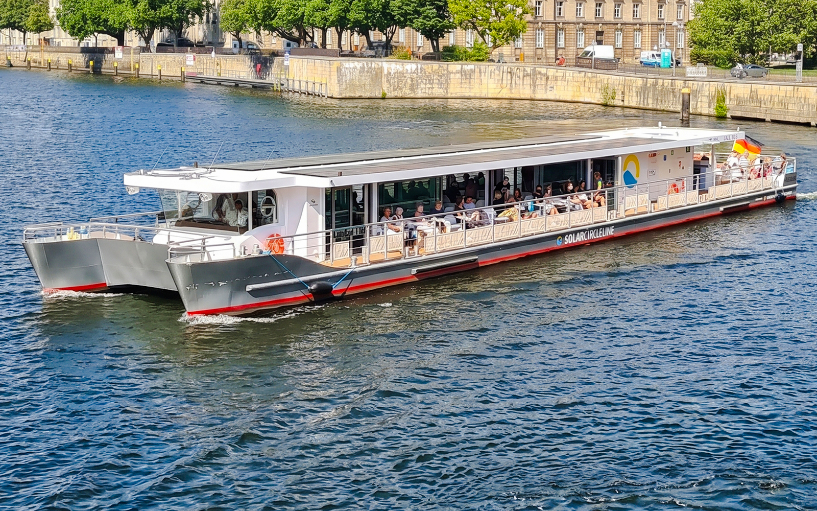 Solar-powered catamaran cruising on the Spree River in Berlin.