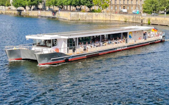 Solar-powered catamaran cruising on the Spree River in Berlin.
