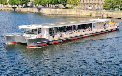 Solar-powered catamaran cruising on the Spree River in Berlin.