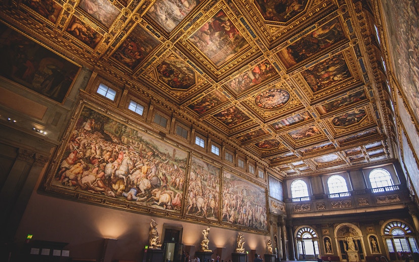 Palazzo Vecchio's ornate hall with frescoes and sculptures, Florence, Italy.