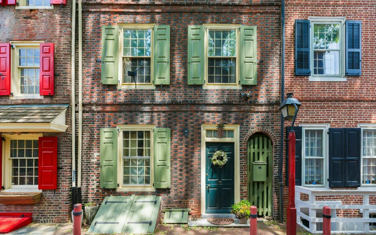 Historic brick row houses with colorful shutters in Philadelphia's Old Town.