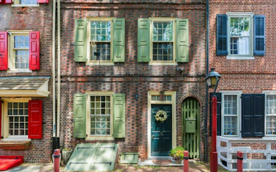 Historic brick row houses with colorful shutters in Philadelphia's Old Town.