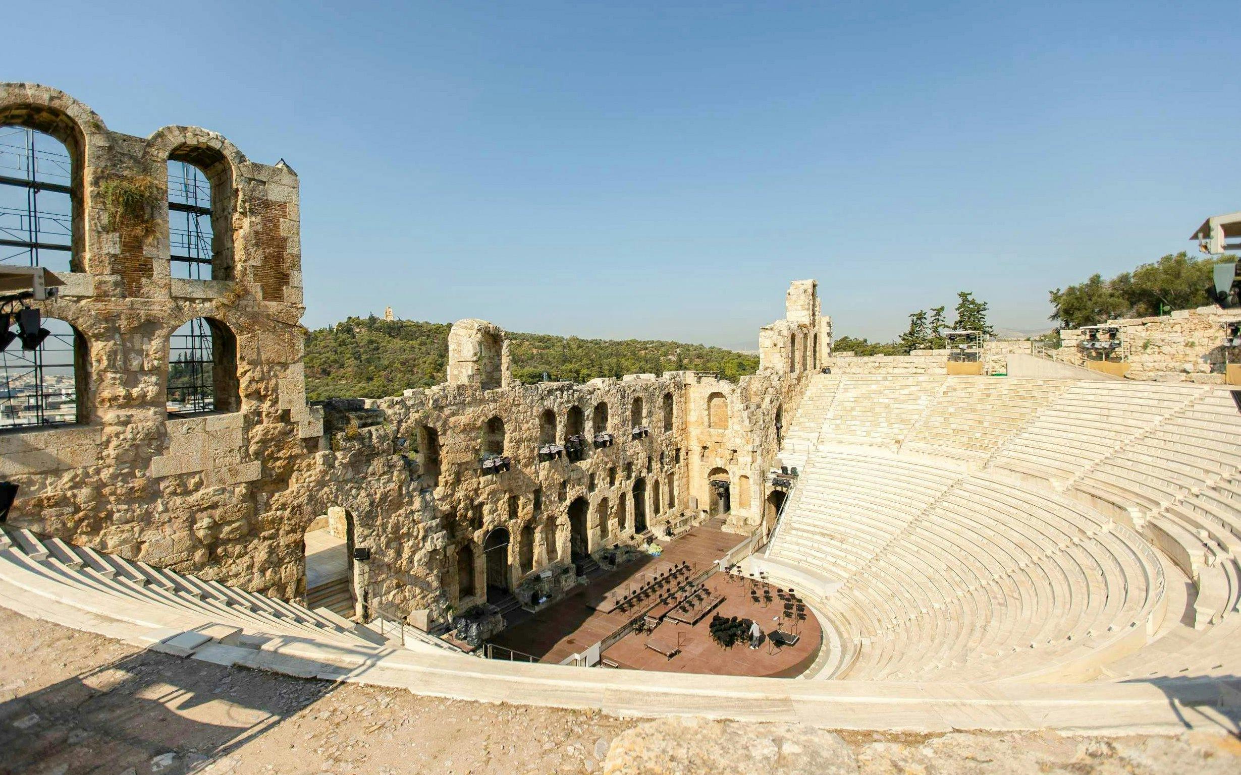 Odeon of Herodes Atticus amphitheater at Acropolis, Athens, with stone seating and stage.