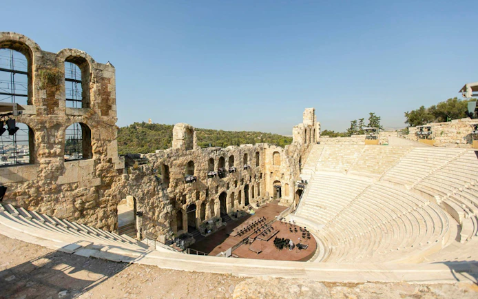 Odeon of Herodes Atticus amphitheater at Acropolis, Athens, with stone seating and stage.