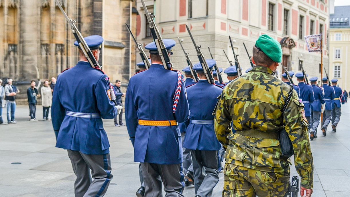 Changing of the Guard ceremony at Prague Castle with soldiers in traditional uniforms.