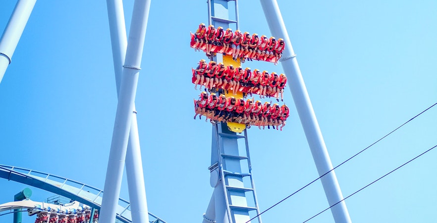 People riding a roller coaster at Dorney Park, suspended upside down.