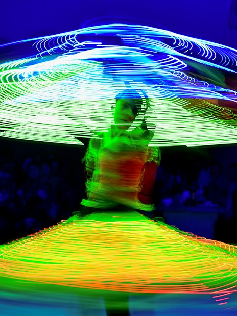 Tanoura dancer spinning with colorful lights on a cruise.