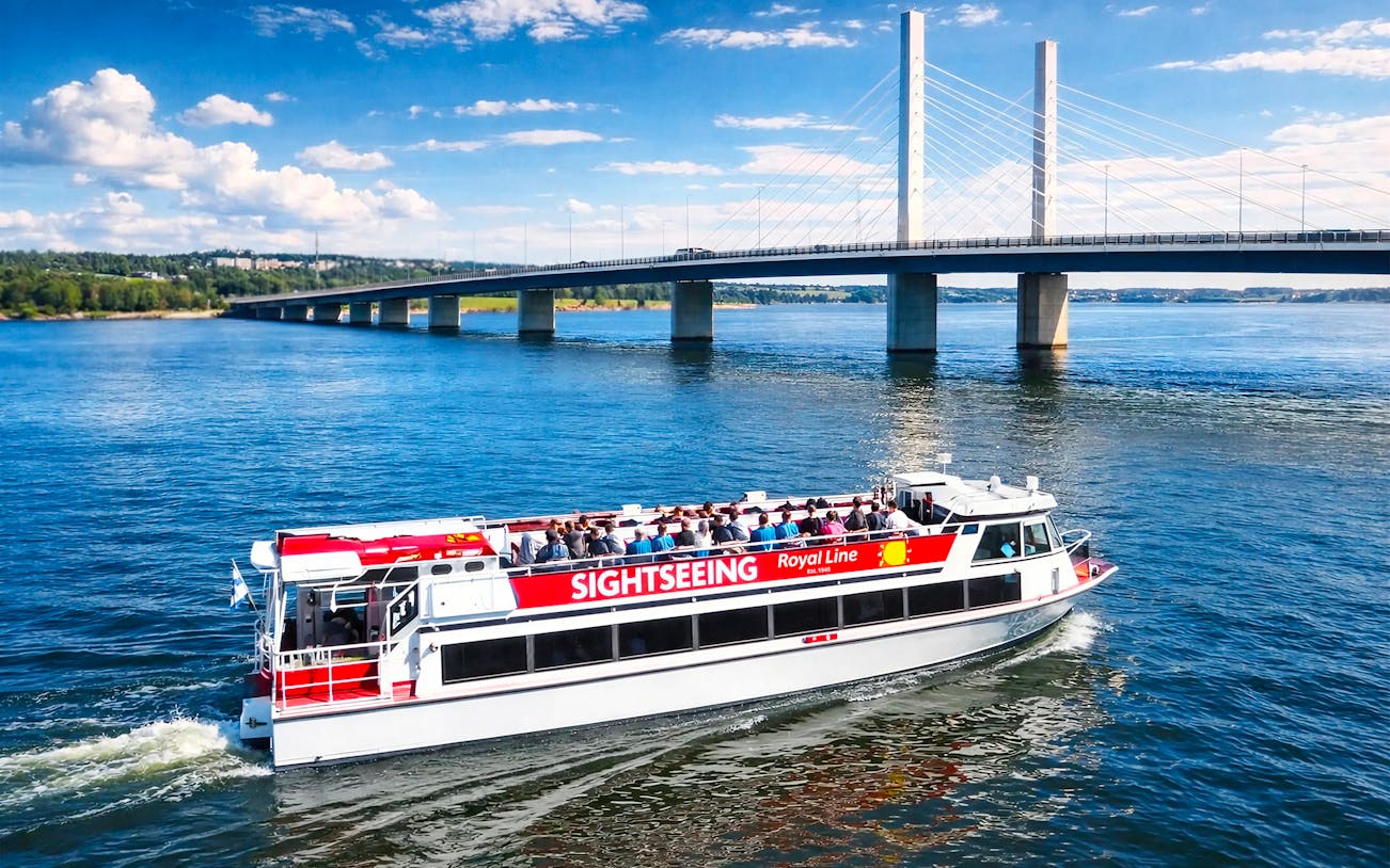 Sightseeing cruise boat near Kruununvuorensilta bridge, Finland.