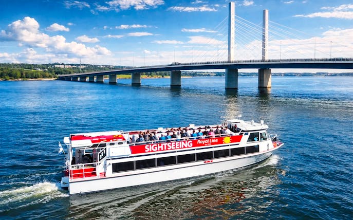 Sightseeing cruise boat near Kruununvuorensilta bridge, Finland.