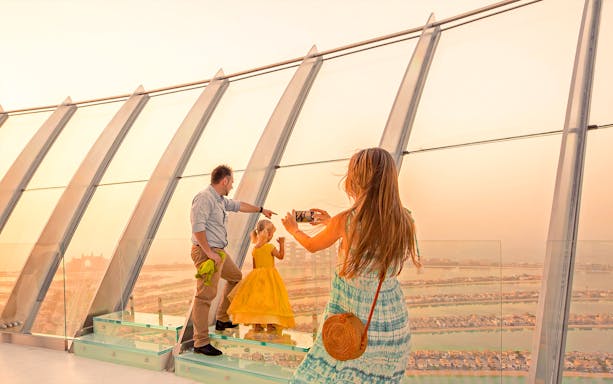 Family enjoying the view from The Palm observation deck in Dubai.