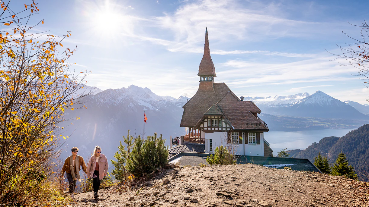 Couple enjoying panoramic view from Harder Kulm summit, Interlaken, Switzerland.