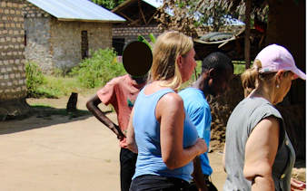 Visitors exploring a local village during the Giriama cultural dance tour in Diani Beach.