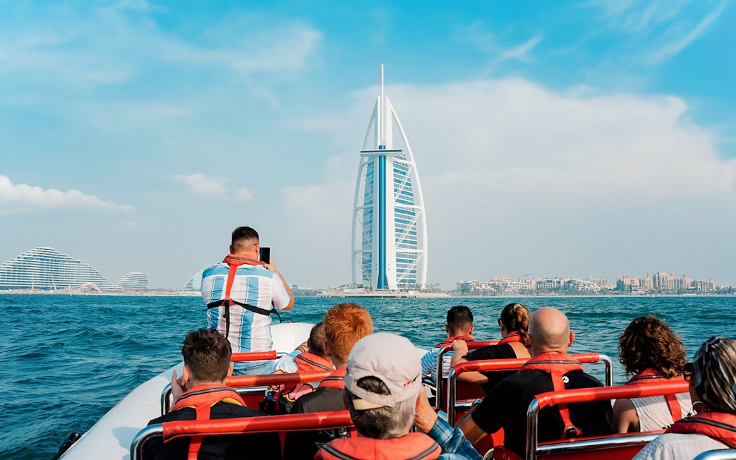 Speedboat tour group viewing Burj Al Arab from Dubai Marina.