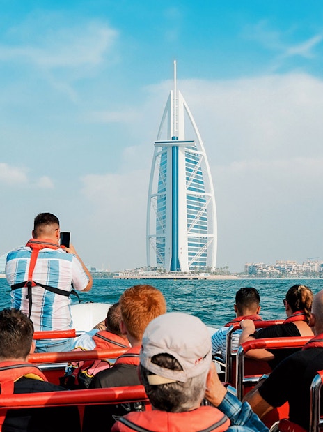 Speedboat tour group viewing Burj Al Arab from Dubai Marina.