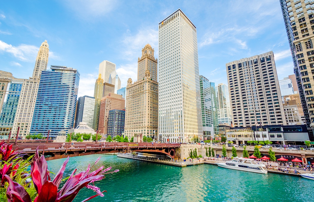 Chicago River with skyscrapers reflecting in the water, showcasing the city's iconic architecture.