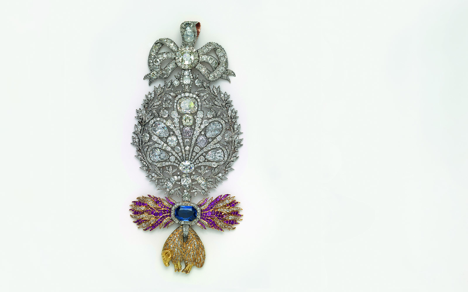 Ornate jeweled brooch with diamonds and colored gems at Royal Treasure Museum.