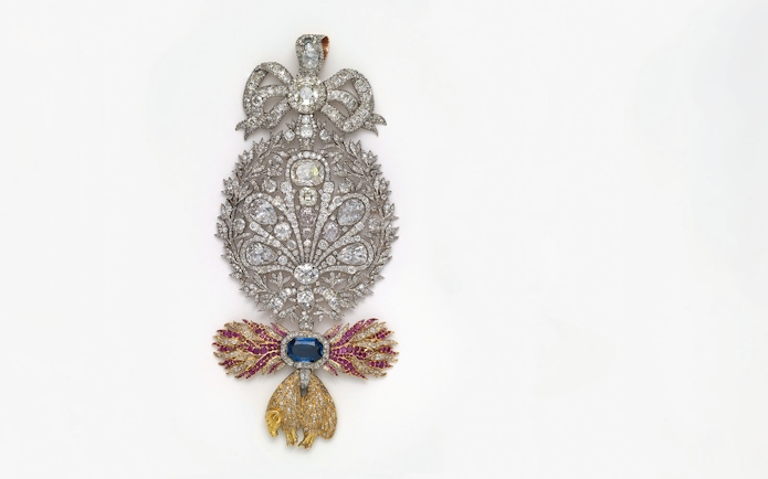 Ornate jeweled brooch with diamonds and colored gems at Royal Treasure Museum.
