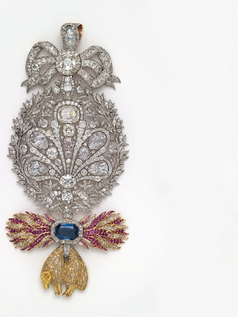 Ornate jeweled brooch with diamonds and colored gems at Royal Treasure Museum.